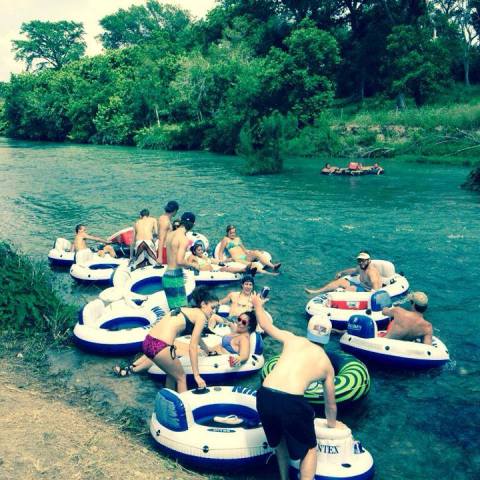 A group of people sitting in tubes before going on a trip
