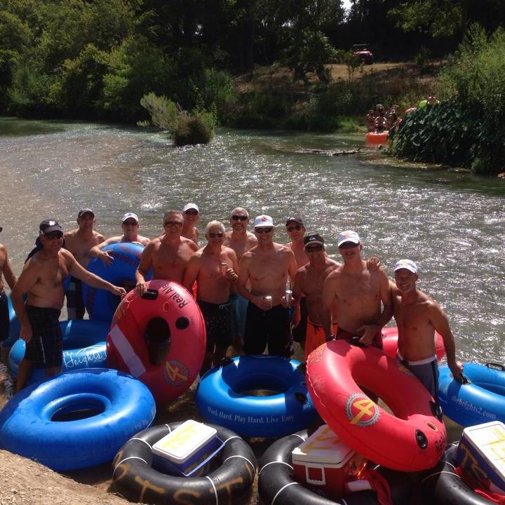 A group of guys gathered around tubes
