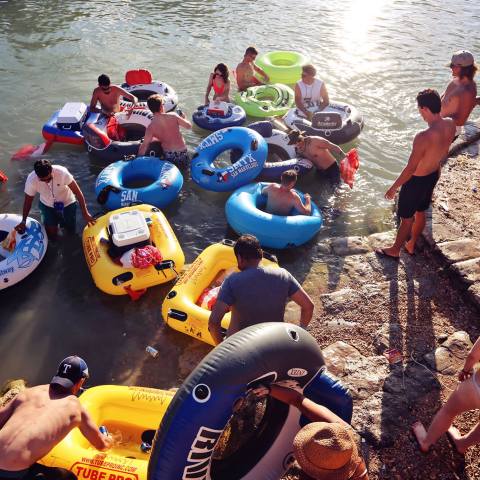 A group of guys with their tubes getting ready to float down the river