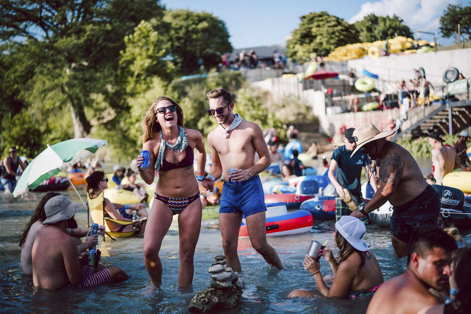 Two girls posing for a picture while standing in the San Marcos River