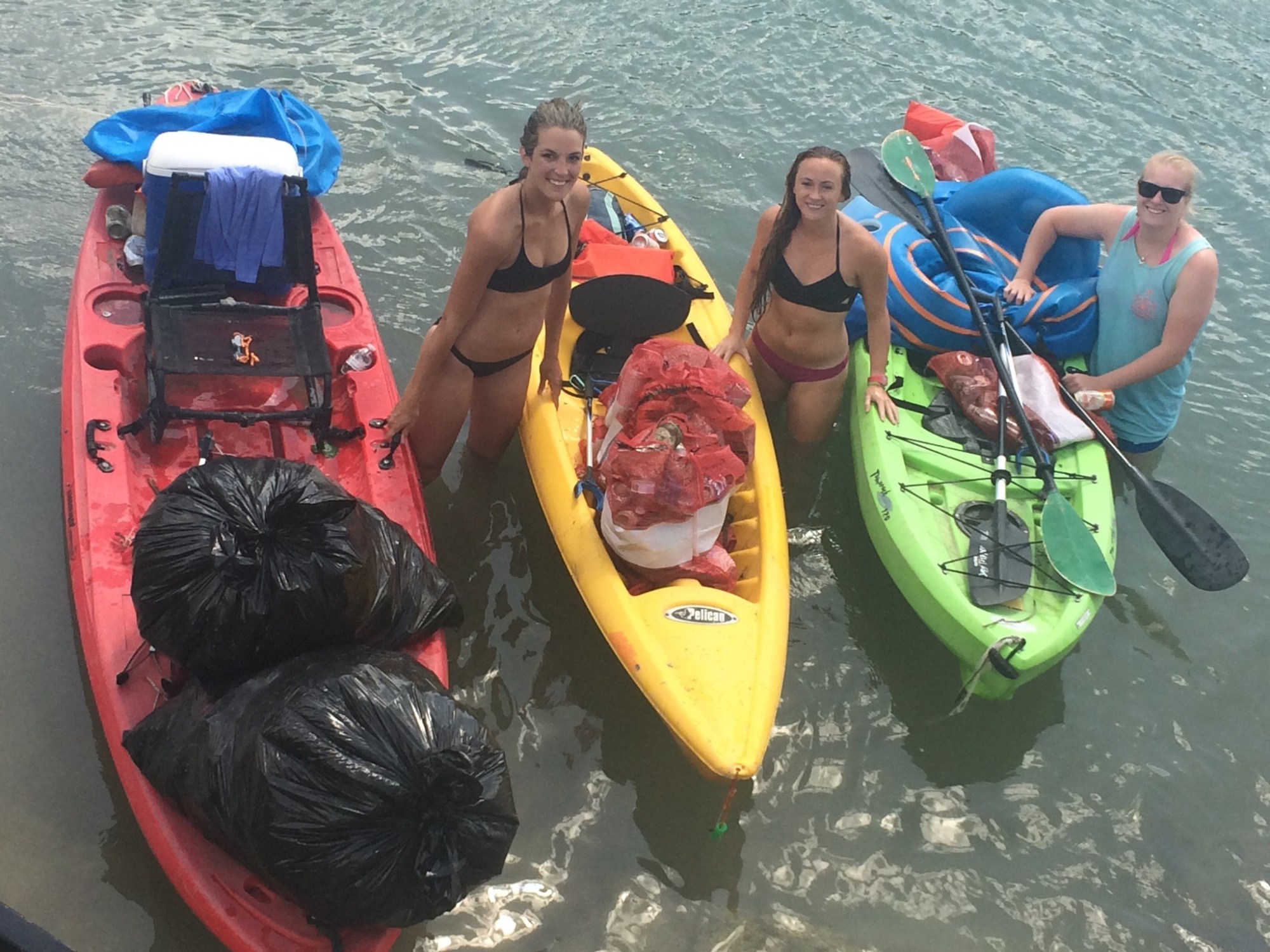 A group of friends sitting in kayaks preparing to float down the river