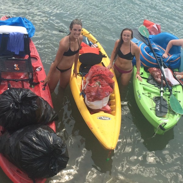 A group of friends sitting in kayaks preparing to float down the river