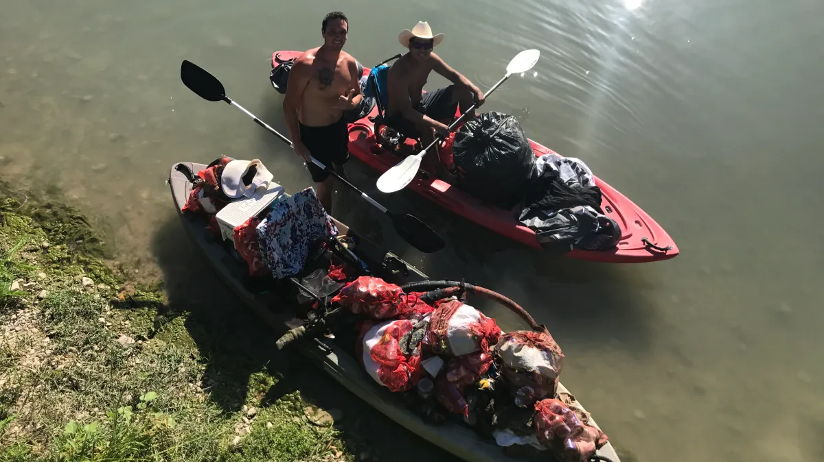 IMG_0156 Two men in a kayak bringing supplies with them