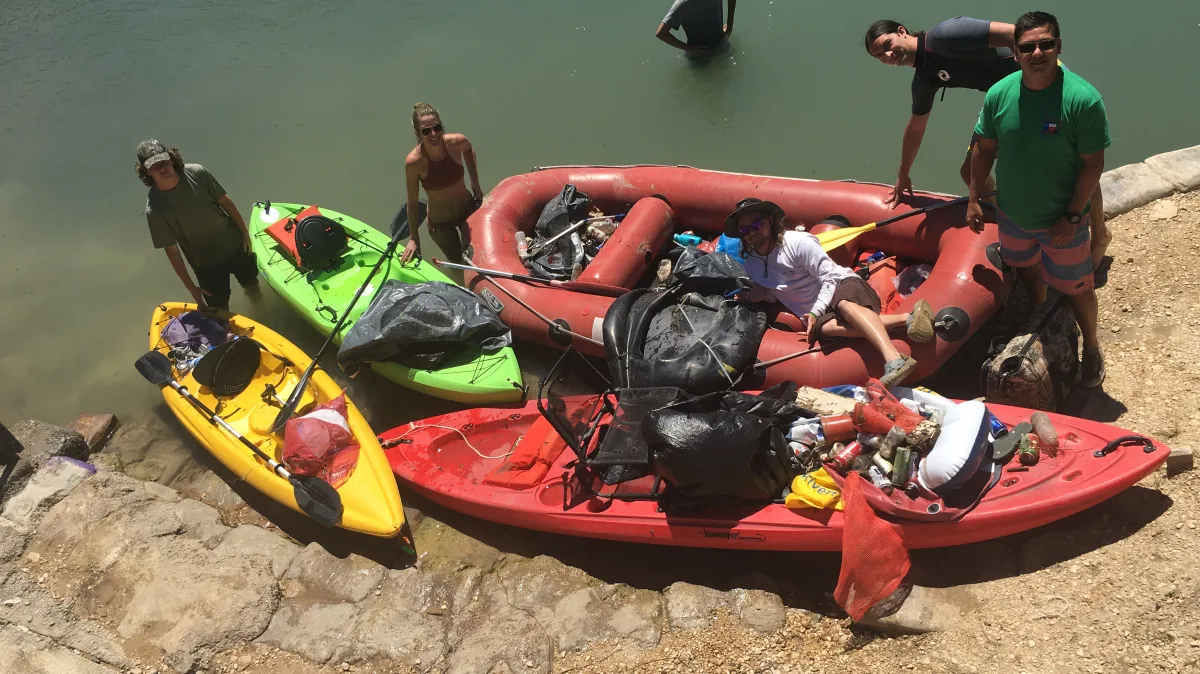IMG_0260 A group of friends loading a kayak with supplies before a float