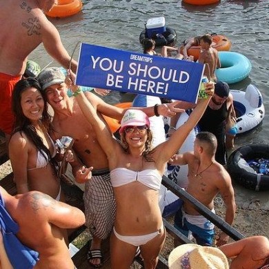 A girl holding up a sign that says 'you should be here'