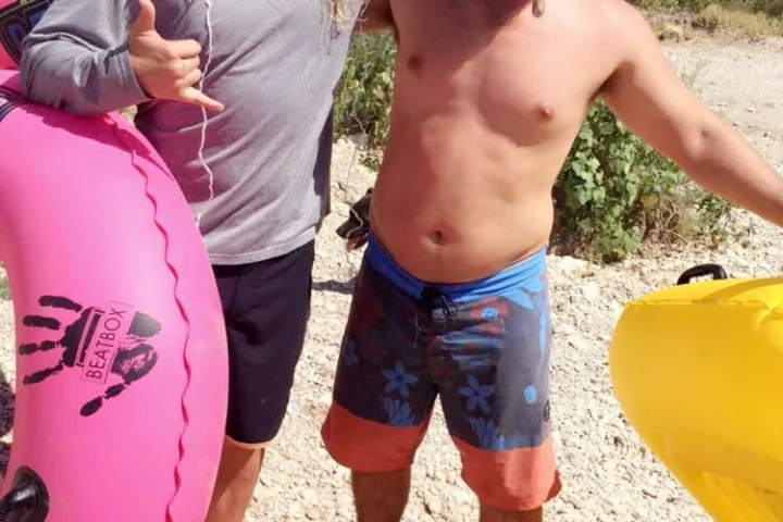 a couple of people that are standing in the sand