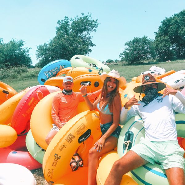 a group of people sitting around a car
